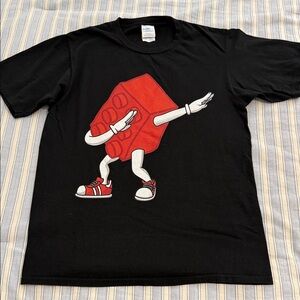 Port & Company Black Dancing Lego T-Shirt. Pit to pit 18.5” length 26”. Size S/P